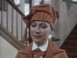 Tuppence in a golfing outfit, the hat is brown and floppy.